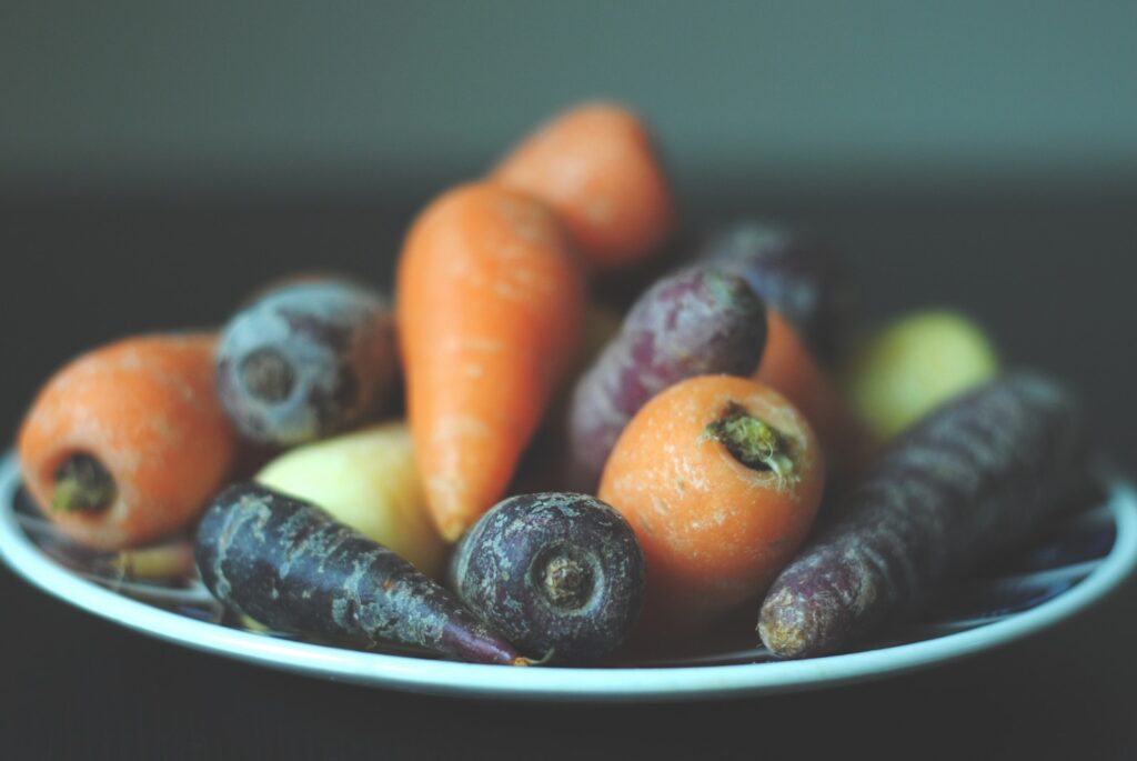 various colored carrots on white plate